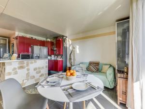 a kitchen and living room with a table and chairs at Apartment Les Vues de l'Argentière by Interhome in Cogolin +13 photos