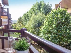 a balcony with a table and plants on a railing at Apartment Le Fairway-6 by Interhome in Deauville