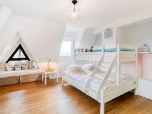 a bedroom with two bunk beds and a couch at Apartment Le Fairway-5 by Interhome in Deauville +18 photos