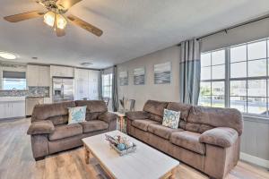 a living room with two couches and a table at Family-Friendly South Padre Island Escape with Grill in South Padre Island