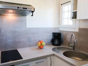 a kitchen with a sink and a bowl of fruit on the counter at Studio Bella Vista by Interhome in Saint-Tropez