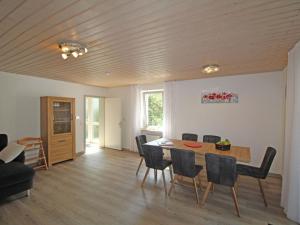 a living room with a dining room table and chairs at Apartment Eifelnatur - Haus 3-2 by Interhome in Immerath