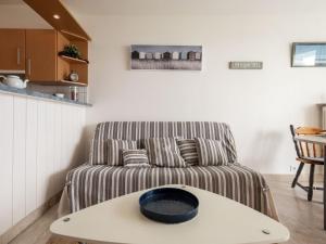 uma sala de estar com um sofá e uma mesa em Studio Les Trois Iles-6 by Interhome em Quiberon