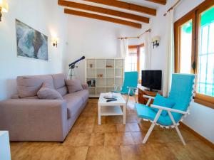 a living room with a couch and blue chairs at Holiday Home Rafol by Interhome in Calpe