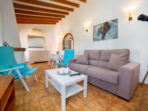 a living room with a couch and a table at Holiday Home Rafol by Interhome in Calpe +18 photos
