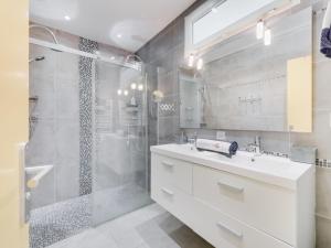 a white bathroom with a shower and a sink at Holiday Home La Colle du Turc by Interhome in Grimaud