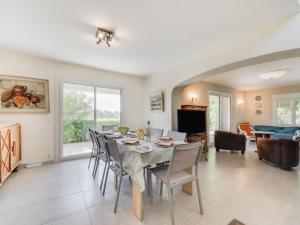 a dining room with a table and chairs at Holiday Home La Colle du Turc by Interhome in Grimaud
