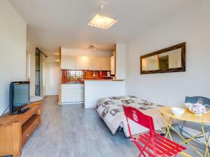 a bedroom with a bed and a table and a kitchen at Apartment Résidence Le Parc by Interhome in Arcachon