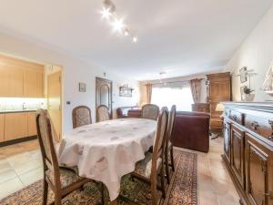 a kitchen and dining room with a table and chairs at Apartment Goldsands II 101 with garage by Interhome in De Haan