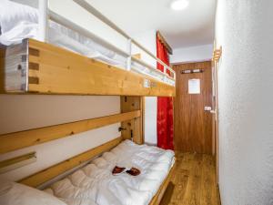 a room with two bunk beds with shoes on them at Studio Rond Point des Pistes-12 by Interhome in Tignes