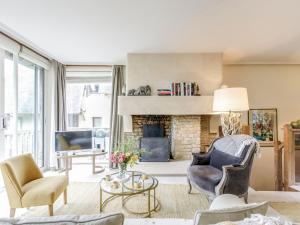 a living room with chairs and a fireplace at Apartment Les Hauts de Deauville-2 by Interhome in Tourgeville