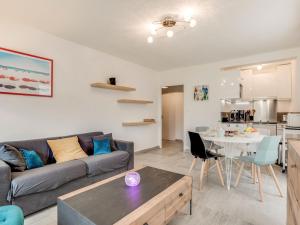 a living room with a couch and a table at Apartment Le Zal-2 by Interhome in Quiberon