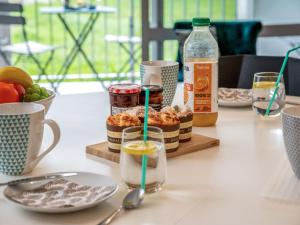 a table with some food and drinks on it at Apartment Le Zal-2 by Interhome in Quiberon