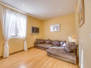 a living room with a couch and a window at Apartment Boulevard Louis Blanc-1 by Interhome in Saint-Tropez
