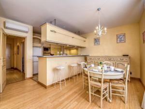 a kitchen and dining room with a table and chairs at Apartment Boulevard Louis Blanc-1 by Interhome in Saint-Tropez +14 photos