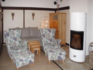 a living room with a couch and two chairs at Holiday Home Landhaus Inselsee by Interhome in Mühl Rosin