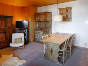 a living room with a wooden table and chairs at Apartment Montagnards 17 by Interhome in Villars-sur-Ollon
