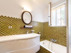 a bathroom with a sink and a mirror at Apartment Village de Silhouette-5 by Interhome in Grimaud