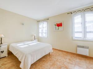 La MôleにあるApartment Le Clos des Vignes by Interhomeの白いベッドルーム(ベッド1台、窓2つ付) +10枚の写真