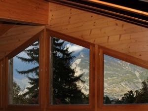 a room with windows with a view of a mountain at Chalet Altamira by Interhome in Plan Fey