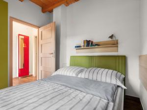 a bedroom with a bed with a green headboard at Holiday Home Bečov nad Teplou 1 by Interhome in Bečov nad Teplou