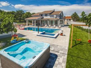 a backyard with a swimming pool and a house at Villa Oasis of peace by Interhome in Gornji Proložac