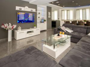 a living room with a couch and a tv at Villa Oasis of peace by Interhome in Gornji Proložac