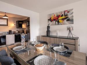 a kitchen and dining room with a table and chairs at Apartment Les grands jardins by Interhome in Saint Malo