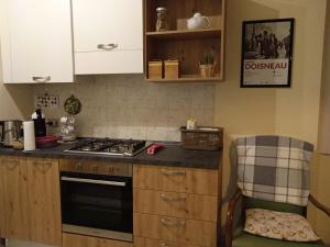 a kitchen with a stove and a counter top at La Casetta in Piazza in Pincara