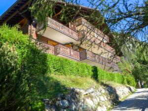 a house with a balcony on a hill at Apartment Colline 1 by Interhome in Champex