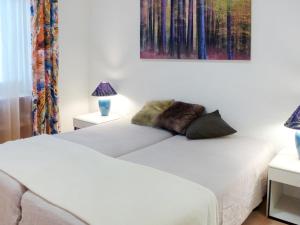 A bed or beds in a room at Apartment Alpes et Lac 28 by Interhome