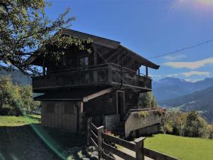 an old house on a hill with a fence at Chalet Feldkasten by Interhome in Dorf