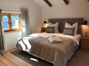 a bedroom with a large bed and a window at Chalet Feldkasten by Interhome in Dorf