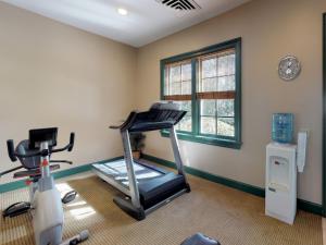 a fitness room with a treadmill and a window at Owners Club At Hilton Head - Managed by Elite Alliance in Hilton Head Island