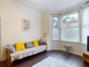 a living room with a couch and two windows at Cheerful 3 bedroom home with free parking and WIFI in Chester