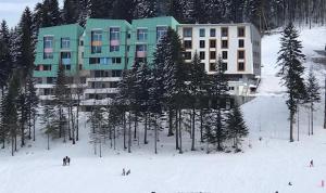 a building on a ski slope in the snow at The View - ski to door in Bjelašnica