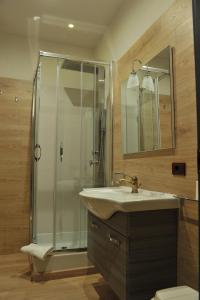 a bathroom with a sink and a shower at Hotel Theotokos in Viggiano