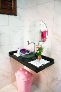 a bathroom with a sink and a mirror at Casa perto da Praia Canto da Barra em Fortim CE in Fortim +34 photos