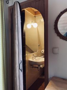 a bathroom with a sink and a mirror at Gościniec Odsapka in Murzasichle