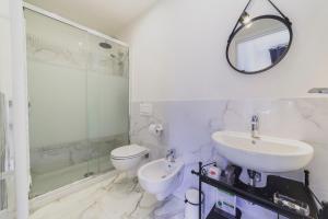 a white bathroom with a sink and a toilet at Lavagnini My Place B&B in Florence