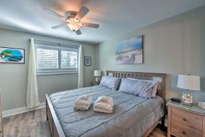a bedroom with a bed with two towels on it at Walkable Hilton Head Island Condo with Resort Perks in Hilton Head Island +25 photos