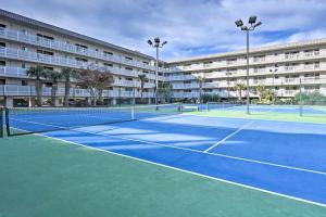 a tennis court in front of a large apartment building at Walkable Hilton Head Island Condo with Resort Perks in Hilton Head Island