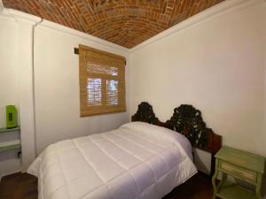 Postel nebo postele na pokoji v ubytování Casa Árbol Hotel