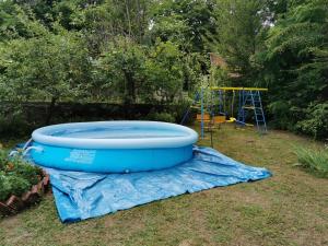 a large blue tub on a tarp next to a playground at Jumiko Apartments in Vrnjačka Banja