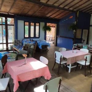 a living room with two tables and a couch at Recanto das Margaridas in Ilhabela