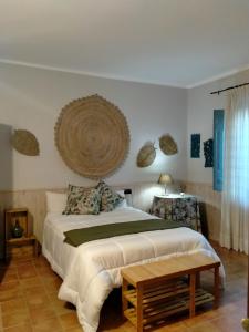 a bedroom with a large bed and a table at Hotel Rural El Cielo Entejado 