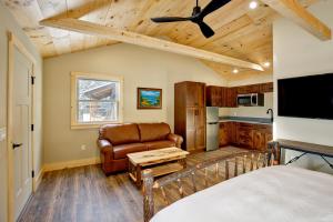 a bedroom with a bed and a couch and a tv at The Lodge by Sunapee Stays in Sunapee