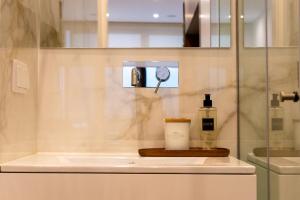 a bathroom with a sink and a bottle of soap at Oliva Teles 53 - Sophia Terrace in Arcozelo +31 photos