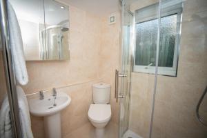 a bathroom with a toilet and a sink and a shower at Stay@27 in Brighton & Hove