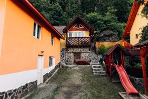 a house with a playground next to a building at Iris Panzio in Praid